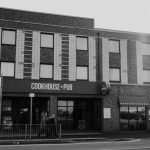 Black and white image of Cookhouse & Pub, Rhyl, showcasing urban architecture.