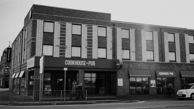 Black and white image of Cookhouse & Pub, Rhyl, showcasing urban architecture.