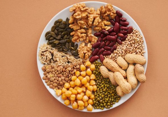 Top view of nuts, beans, and seeds on a plate, ideal for healthy dining themes.